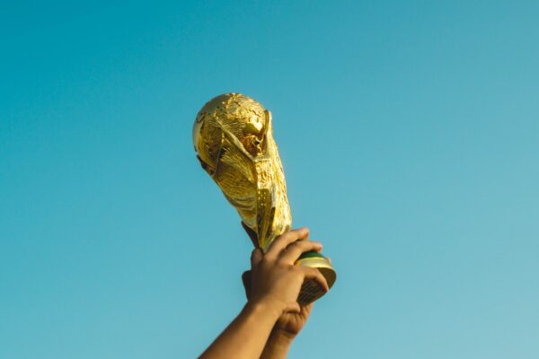 person holding gold trophy