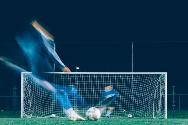 timelapse photo of soccer player kicking ball