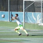 man playing soccer during daytime