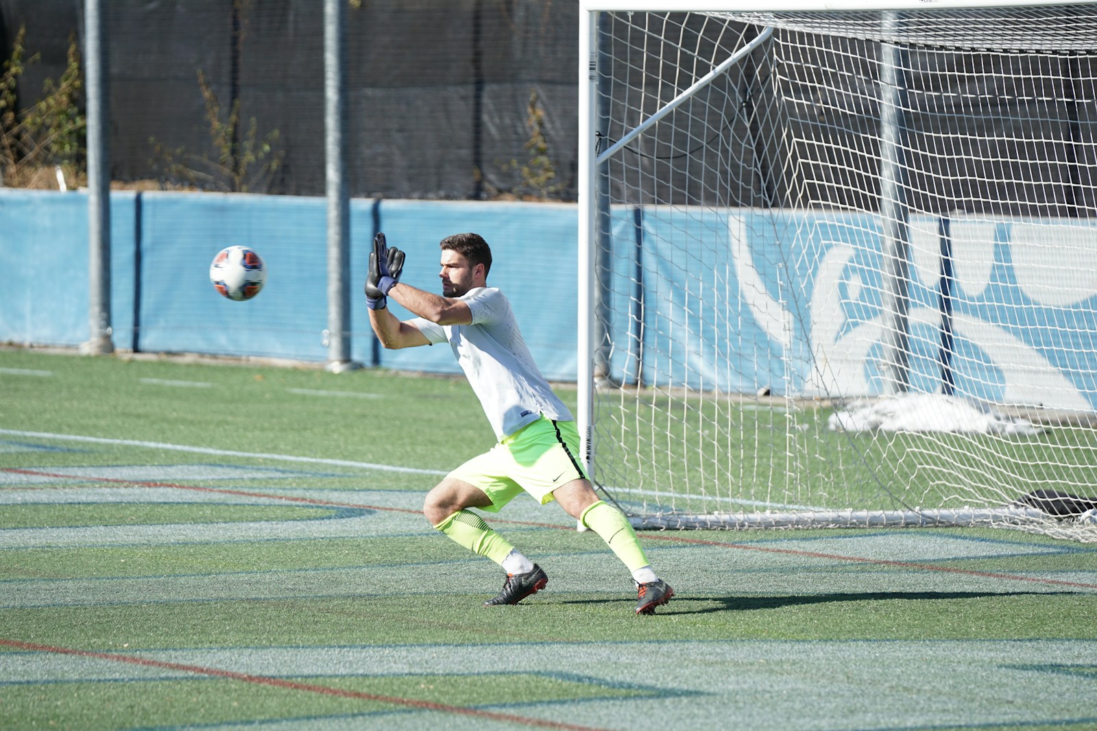 man playing soccer during daytime