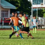 men's playing soccer during daytime